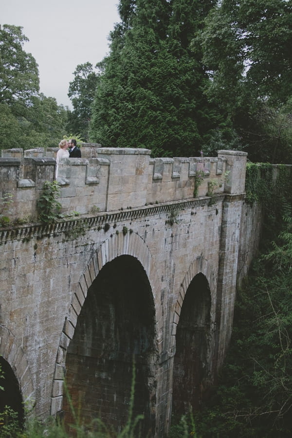 Bride and groom on bridge