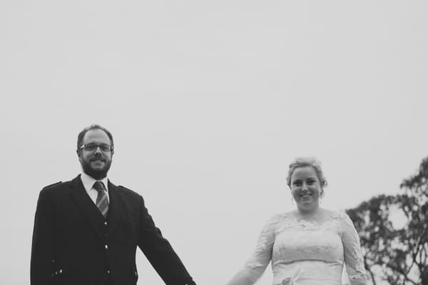 Bride and groom holding hands