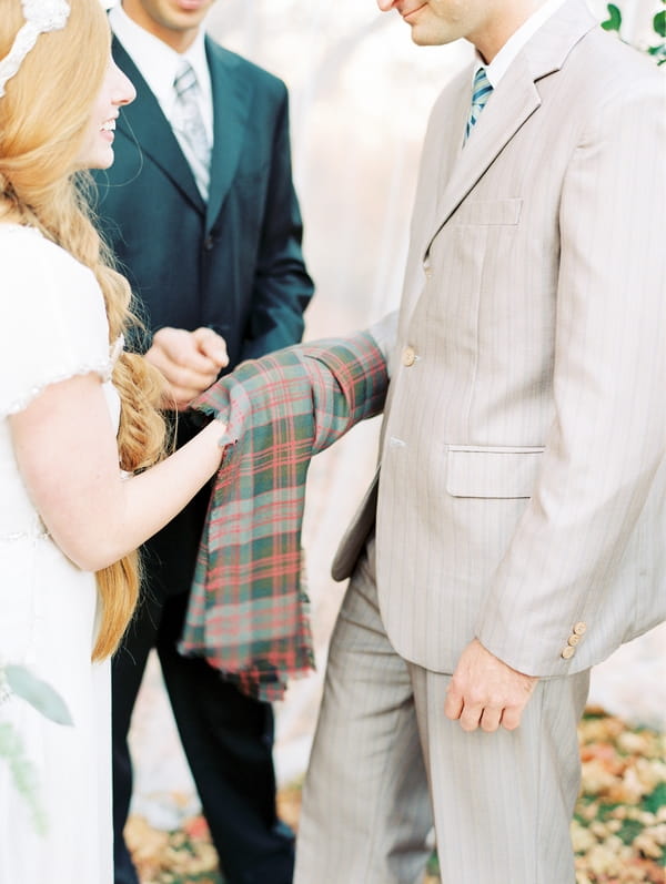 Clad Tartan over hands in wedding ceremony