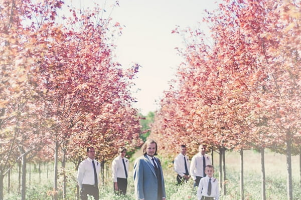 Groom and groomsmen surrounded by trees