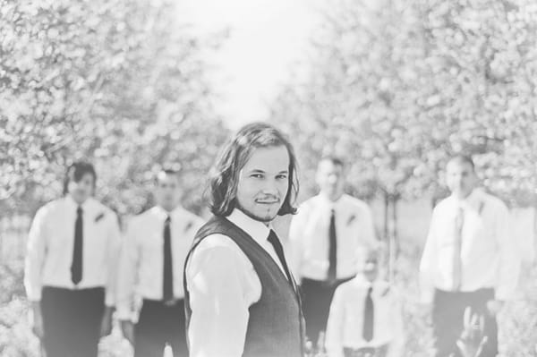 Groom with groomsmen in background