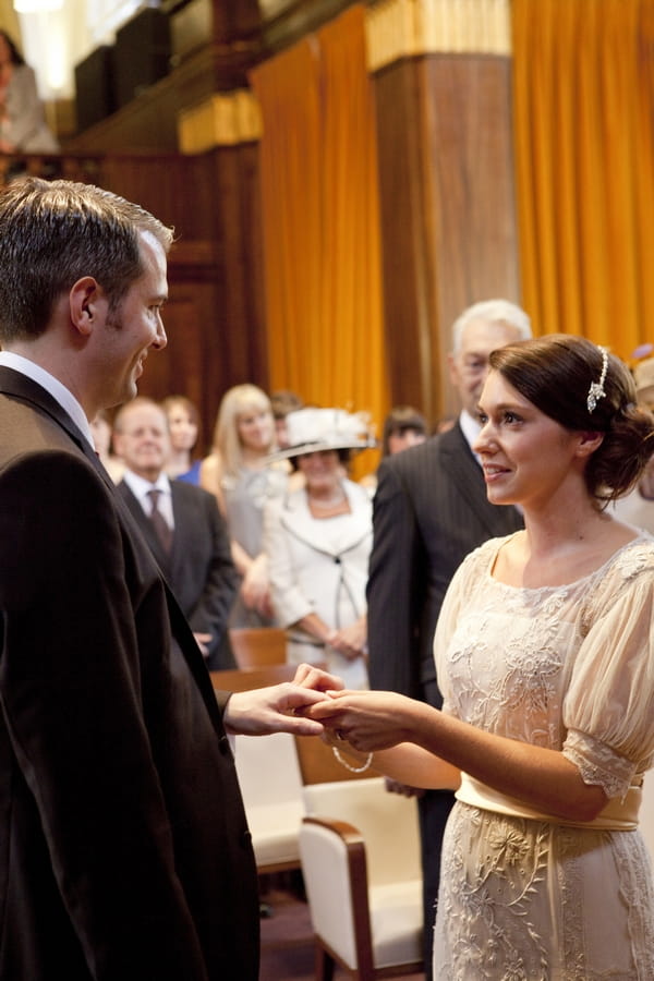 Bride and groom exchanging rings in Town Hall