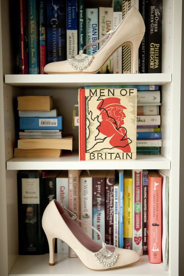 Wedding shoes on book shelf