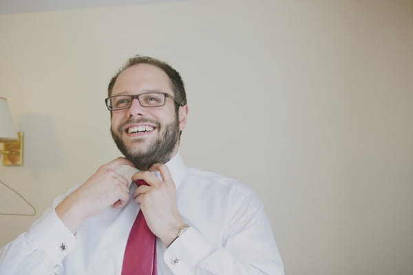 Groom doing up tie