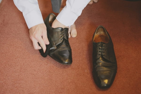 Groom cleaning shoes