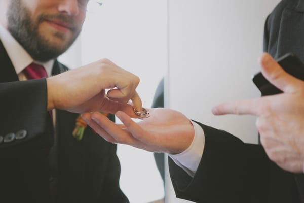 Groom giving best man rings