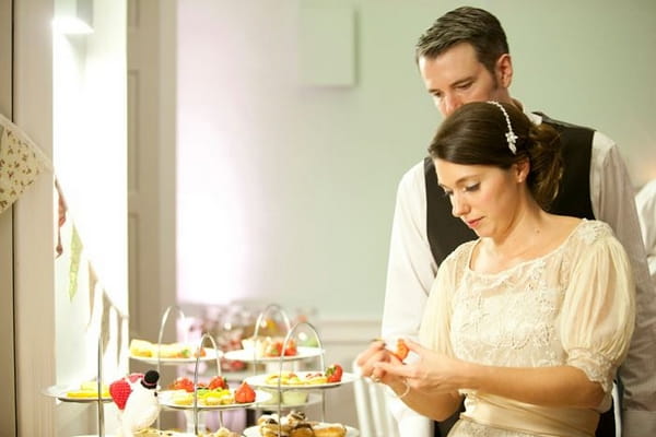 Bride and groom at sweet table