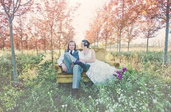 Bride and groom sitting on couch