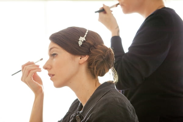 Bride applying mascara