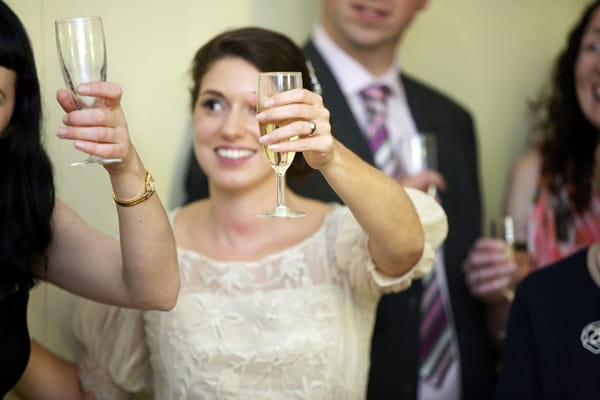 Bride raising glass to toast