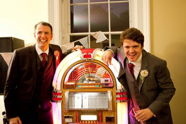 Groom and best man next to juke box