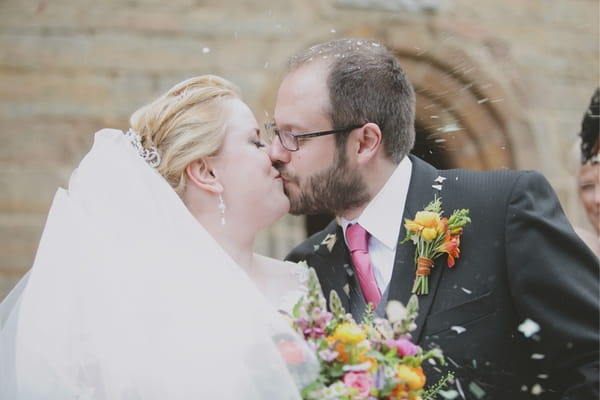 Bride and groom kiss