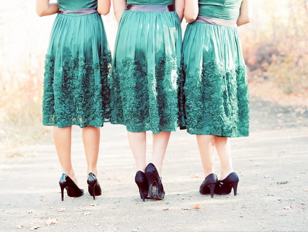 Back of bridesmaids in green dresses