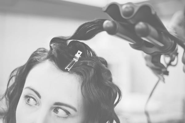 Bride having hair styled