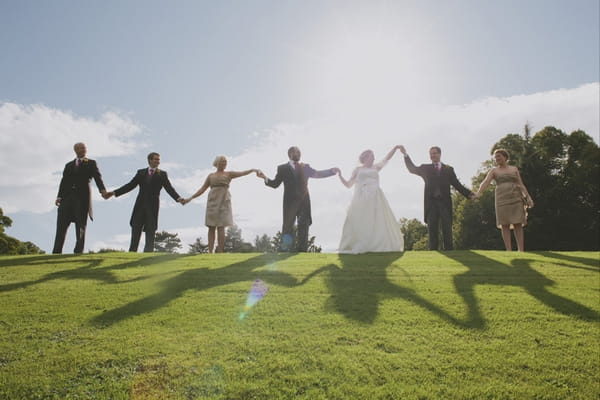 Bridal party holding hands