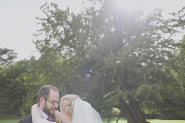 Bride with arms around groom