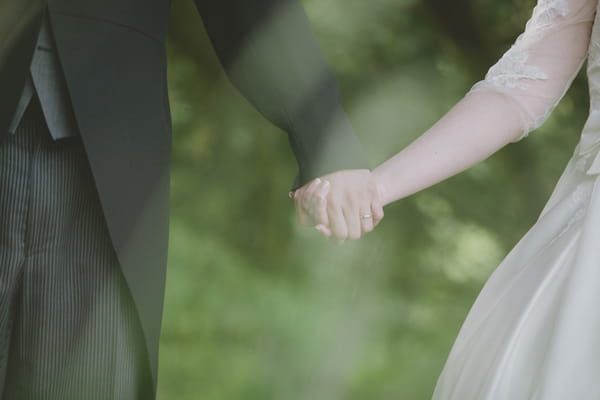 Bride and groom holding hands