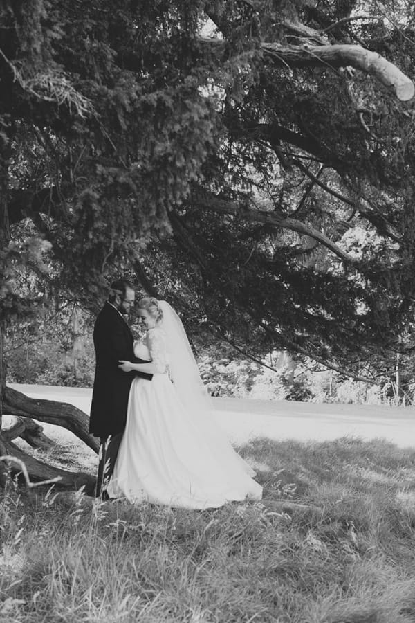 Bride and groom under tree