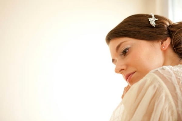 Bride putting on earring