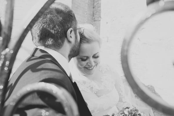 Groom kissing bride's head