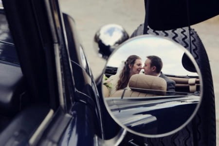 Bride and groom reflection in wing mirror of vintage car - Picture by Jenna Carpenter Photography