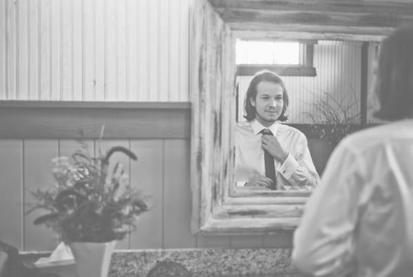 Groom adjusting tie