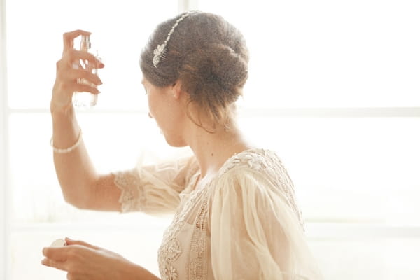 Bride spraying perfume