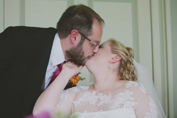 Groom kissing bride