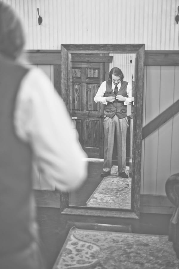 Groom looking in mirror