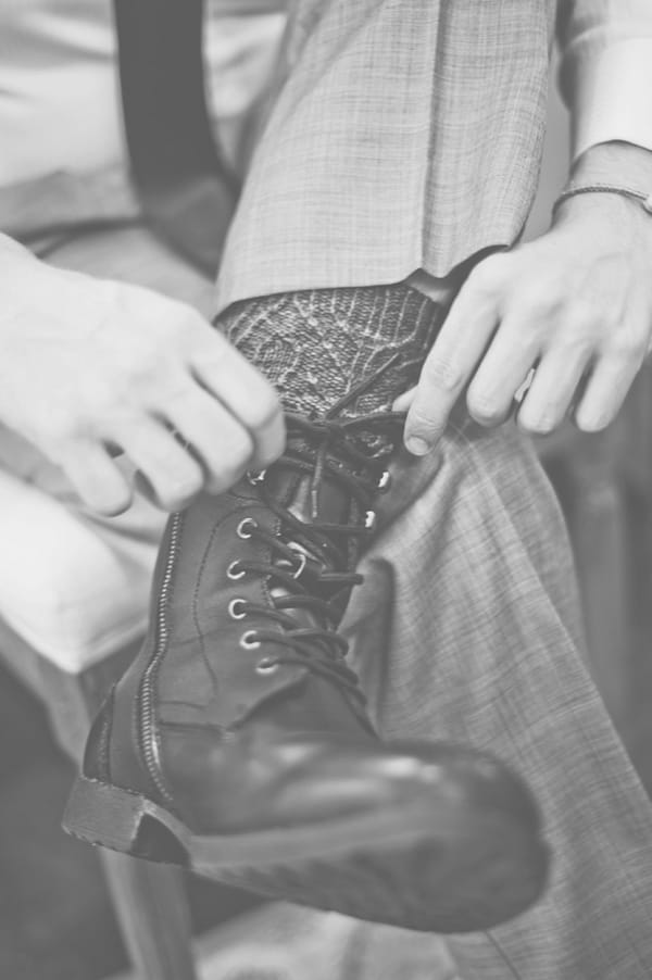 Groom putting on boots