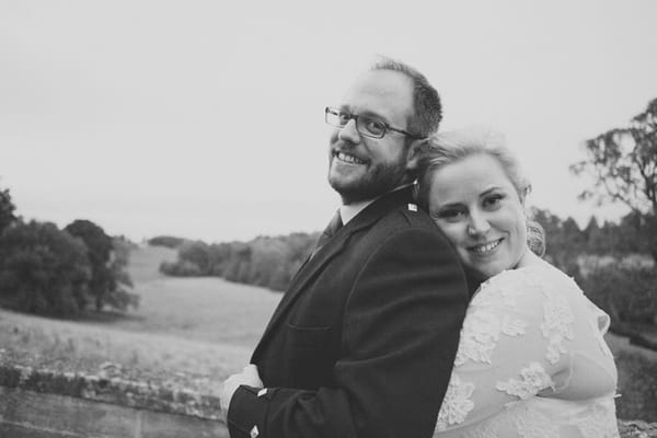 Bride with arms around groom's waist