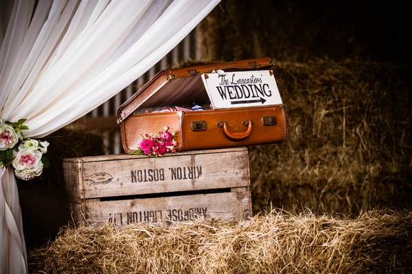 Vintage suitcases on hay bales