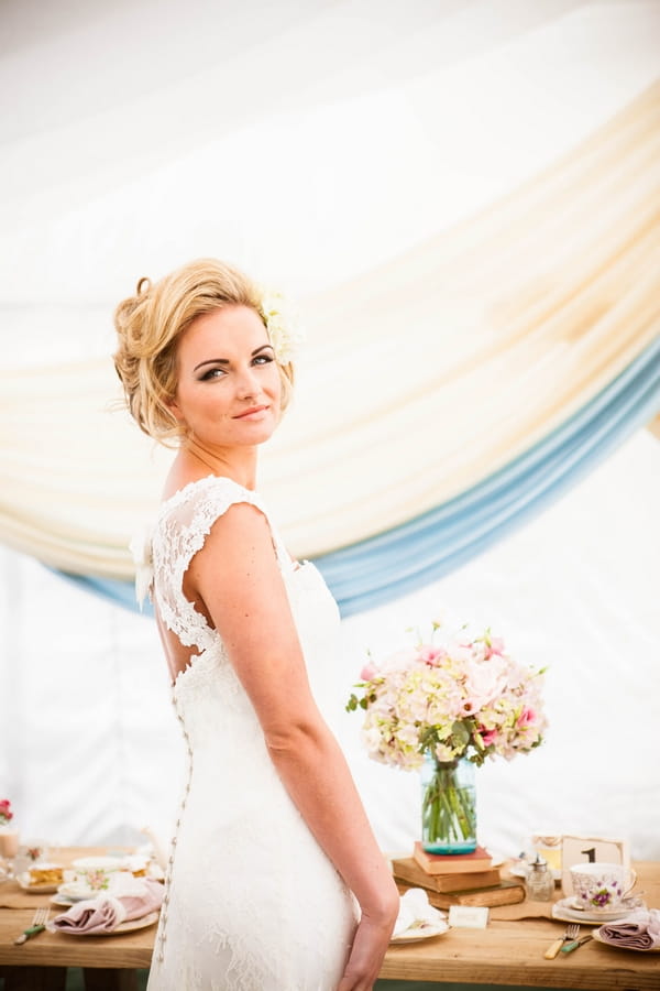 Bride standing in front of table