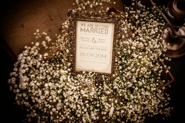 Flowers around wedding sign