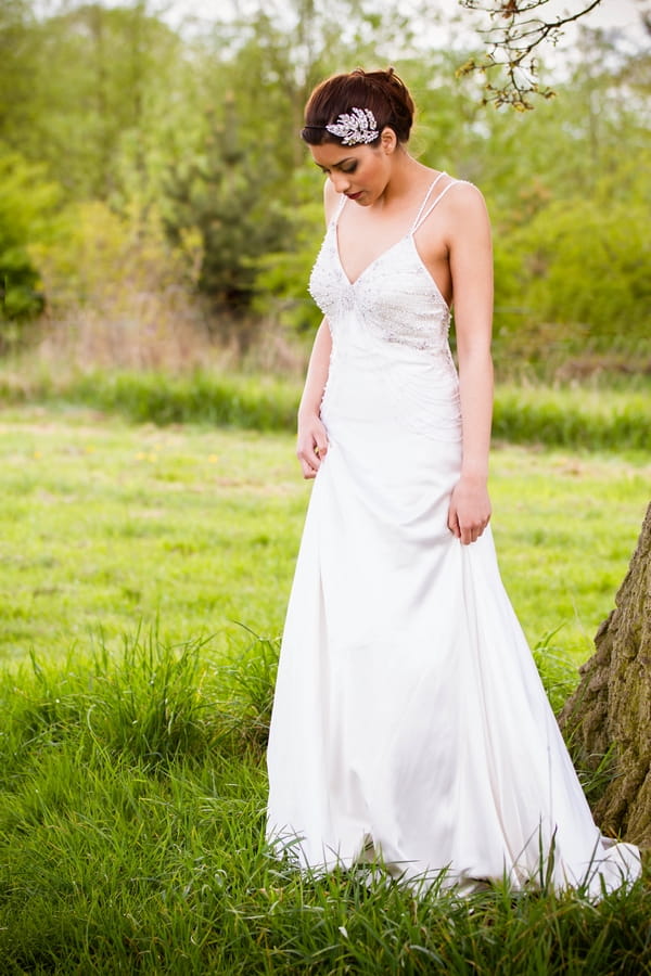 Bride looking down at grass