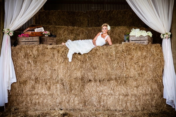 Bride layig on hay bales