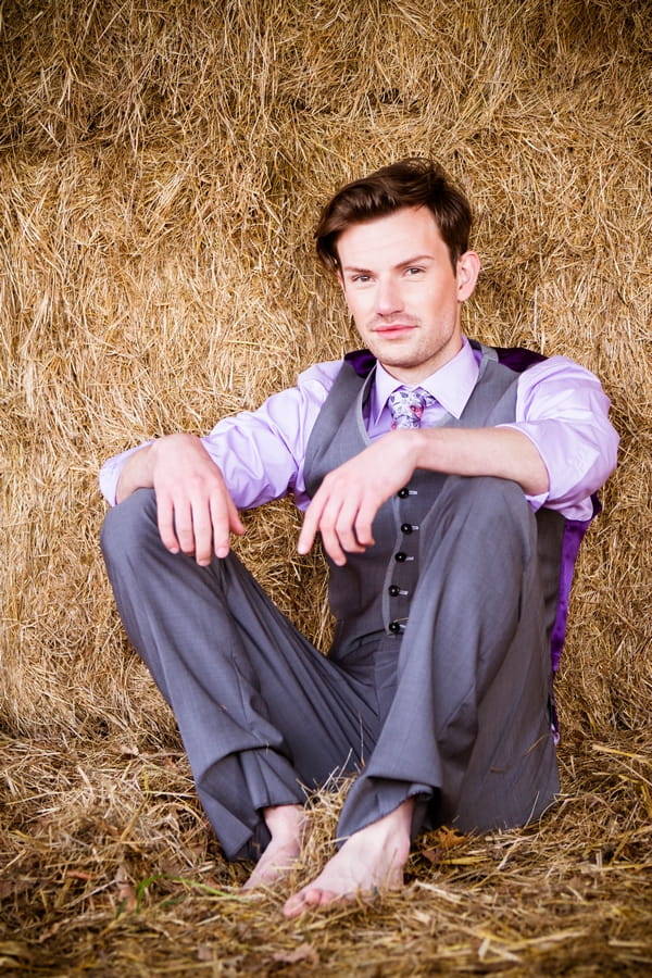 Groom sitting on hay