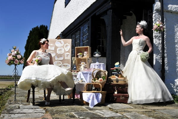 Two brides with wedding props