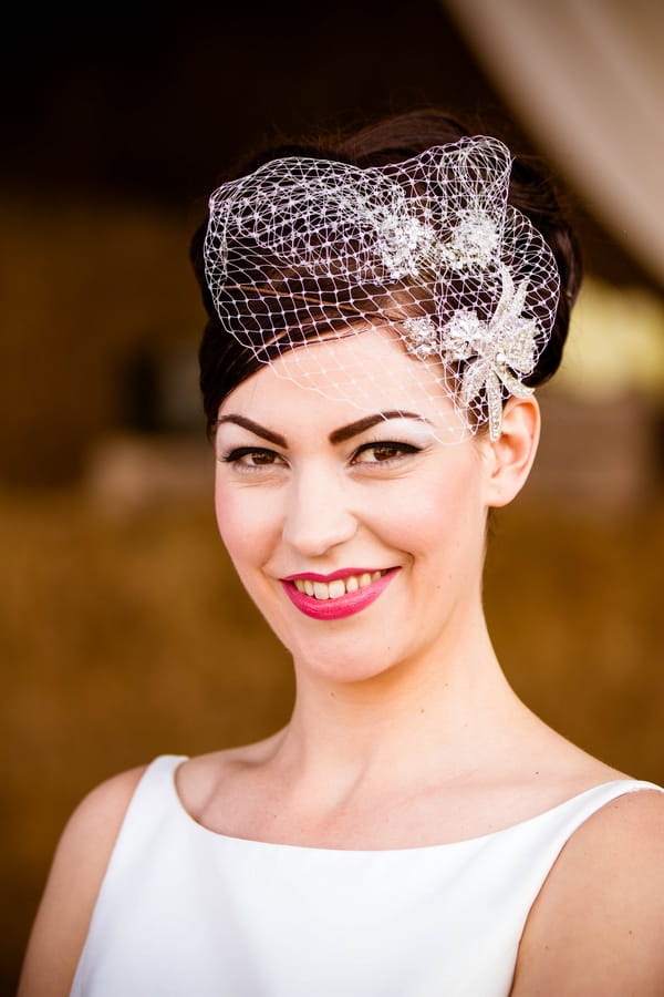 Vintage bride wearing birdcage fascinator