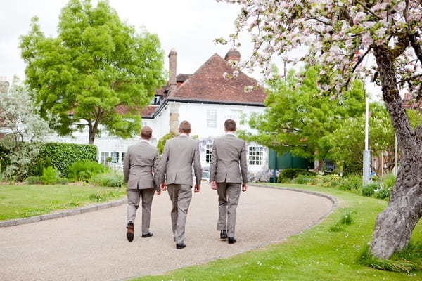 Groomsmen walking to wedding venue