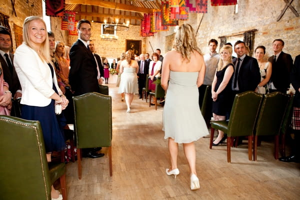 Bridesmaid walking into wedding ceremony