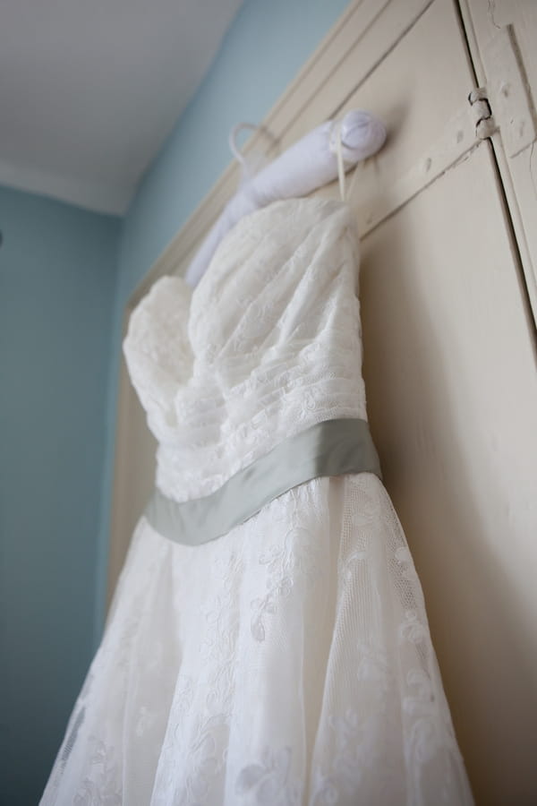 Wedding dress with green sash