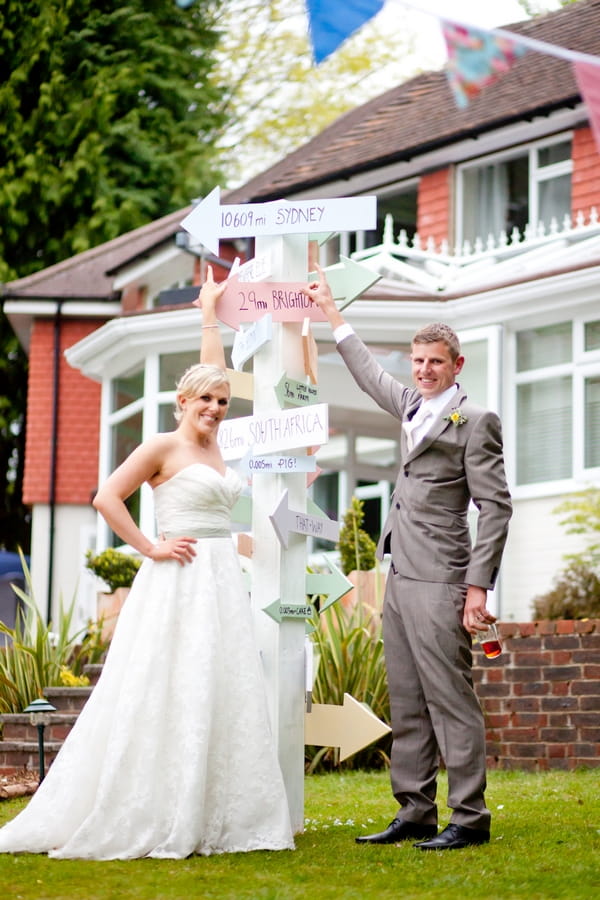 Bride and groom by homemade sign post