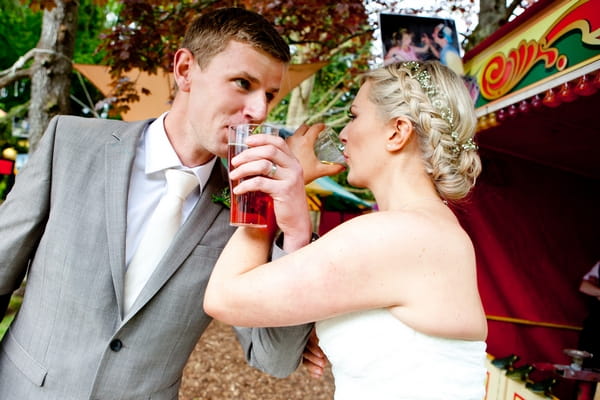 Bride and groom drinking