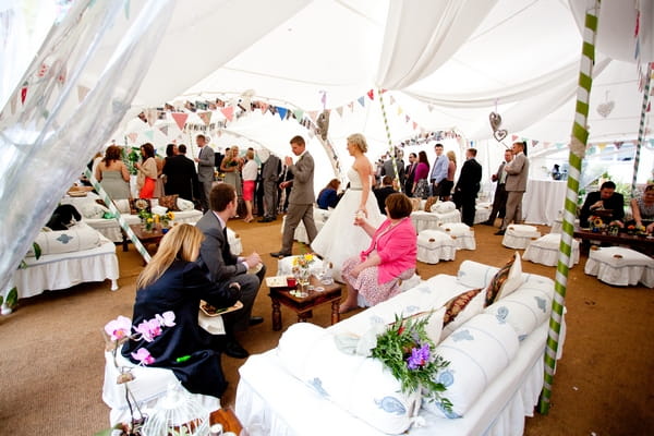 Bride and groom entering marquee wedding reception