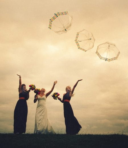 Bride and bridesmaids throwing umbrellas in the air - Picture by DSB Creative