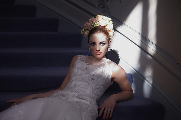 Bride leaning on stairs - Hair and Makeup by Claire Salter