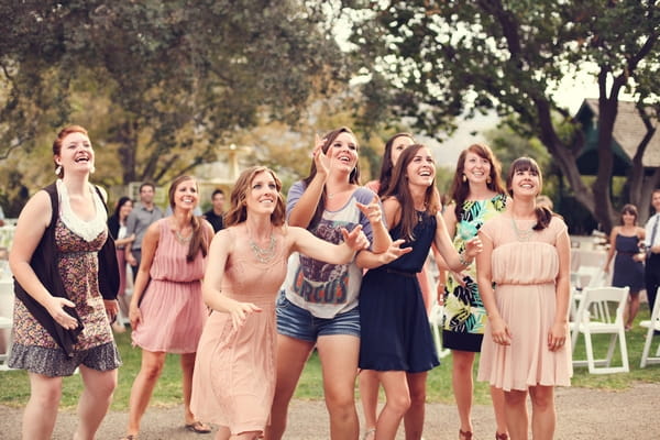 Women trying to catch bouquet