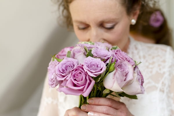 Bride smelling bouquet