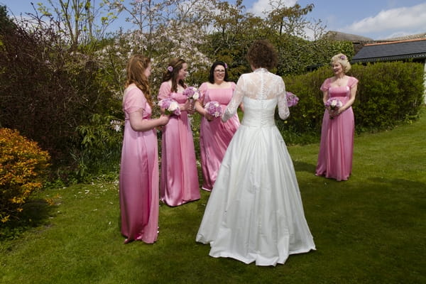 Bride with bridesmaids in pink dresses